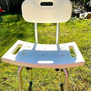 White plastic freestanding shower chair with back